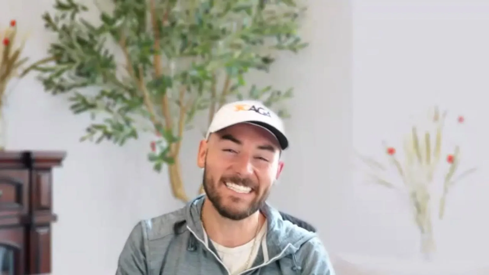 Clay Adelizzi smiling in a SCAGA cap while hosting an Amateur Edge interview.